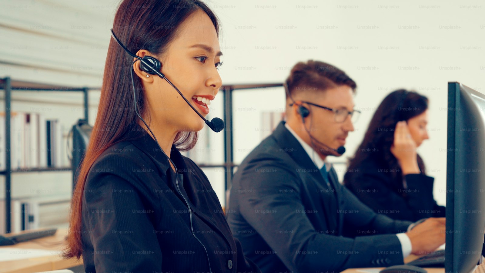 Person wearing a headset and working at a computer