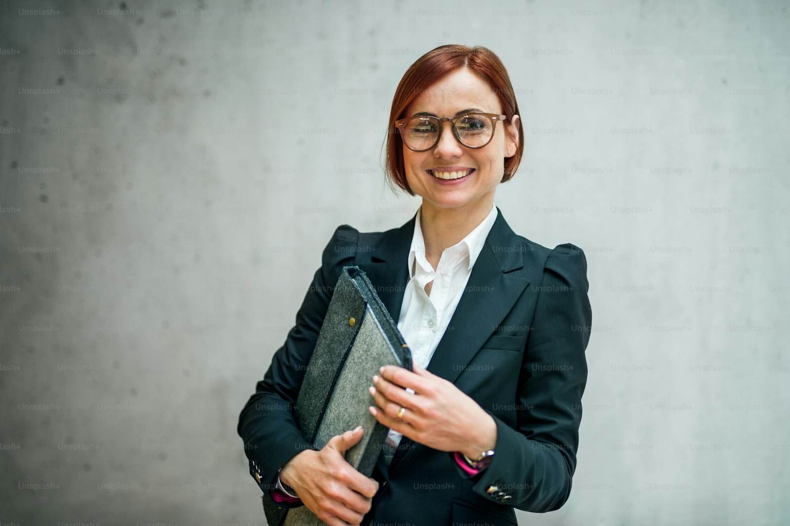 Person in a suit holding a portfolio